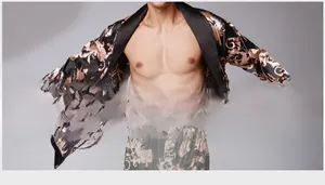 Detail of black silk-like satin robe featuring golden dragon and vine patterns