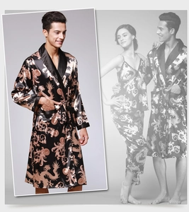 Detail of black silk satin men robe featuring golden dragon print and belted waist