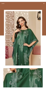 Detail of green satin plus size kaftan with white paisley prints and floral sleeve patterns