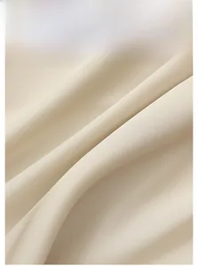 Close-up of lightweight beige satin fabric showing smooth texture and elegant drape