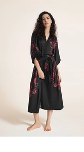 Detail of black satin kimono robe for women featuring elegant red cherry blossom patterns