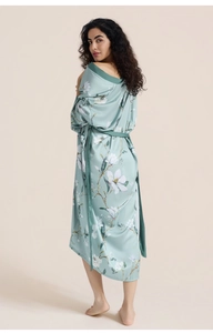 Detailed view of luxury satin kimono robe with magnolia print and silky fabric texture