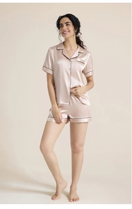 Detailed view of champagne pink silk pajama set with contrast black piping and chest pocket