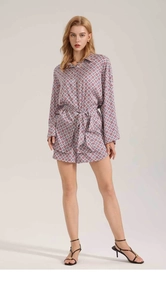 Detail of retro geometric tile print on satin long sleeve shirt with matching belt