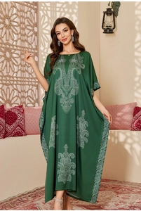 Detail of satin kaftan robe with white totem print in dark green bohemian style