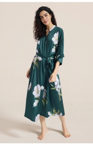 Detailed view of dark green satin robe featuring large white and lavender floral prints