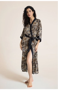 Detail view of smooth satin fabric and leopard print pattern on the women's long bathrobe