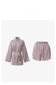 Detail of vintage geometric print satin pajama set showing long-sleeve top and shorts