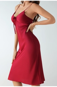Detail of red satin nightgown featuring slim straps, chest lacing and silky fabric texture