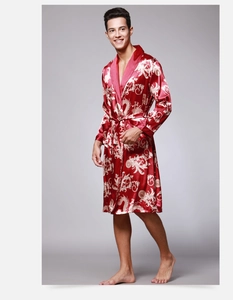 Detail of red silk-like satin men's robe featuring golden dragon and baroque patterns