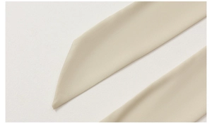 Detailed macro view of the premium satin sleepwear fabric and smooth seam edges