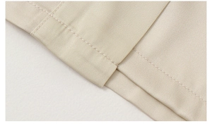 Detailed close-up showing precision stitching on the hem of a satin floral robe