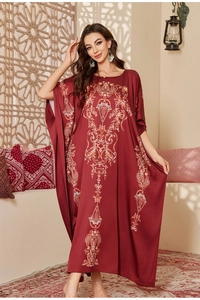 Detail view of red satin kaftan with bohemian print and ethnic middle eastern style
