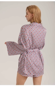 Detail view of the geometric print satin pajama set showing wide sleeves and back drape
