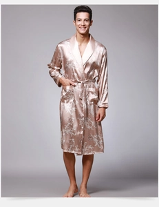 Detail of champagne gold satin robe with elegant baroque pattern and waist belt