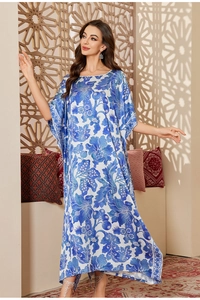 Detail of blue floral satin kaftan robe featuring loose silhouette and elegant patterns