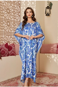 Detail of blue floral print satin kaftan dress with relaxed batwing sleeves and long hem