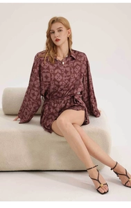 Detail of satin long sleeve shirt with geometric patterns and waist tie in deep purple