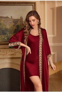Close-up of elegant burgundy satin robe set with vintage gold embroidery on cuffs