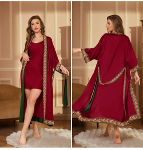 Detail of dark red satin robe featuring golden vine patterns and a green waist tie