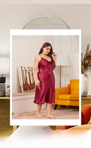 Detail of wine red satin nightdress with draped neckline and smooth glossy fabric texture
