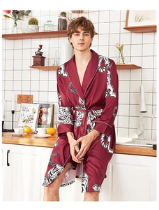 Detail of burgundy silk satin men's robe featuring bold tiger print and white piping