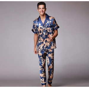 Detail of silk-satin men's pajama set featuring golden dragon and baroque patterns