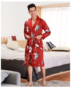 Detail of red silk bathrobe for men featuring white crane prints and belted waist design