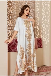 Detailed golden floral embroidery on a white satin kaftan robe with side slits