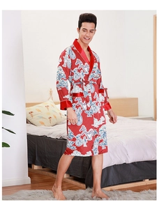 Detailed close-up of men's red silk pajamas with traditional Chinese pattern and satin trim