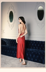 Détail d'une nuisette en satin rouge avec bretelles croisées et texture élégante en soie