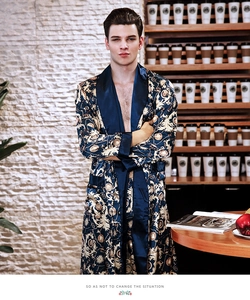 Detail of luxury men's silk satin bathrobe with golden baroque patterns and contrast lapel