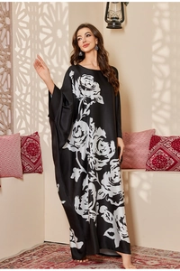 Chiffon kaftan with white floral prints and batwing sleeves in a home setting