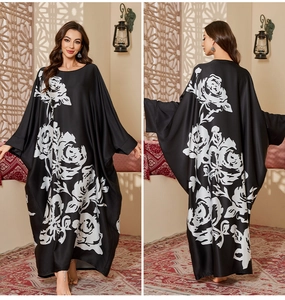 Detail showing the front and back of a black satin robe with large white rose prints