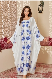 Detail of white satin kaftan with blue rose print and wide batwing sleeves design
