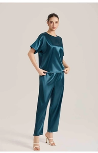 Detail of silk satin pajamas set in deep teal with short sleeves and straight pants