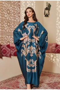 Detail of luxurious navy satin kaftan with gold baroque patterns and pink floral prints