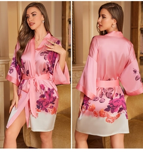 Detail of pink floral satin robe with gradient hem and elegant three-quarter sleeves