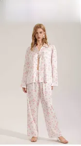 Detail of satin long-sleeve pajamas with pink heart pattern and a belted waist