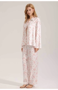 Detail of white satin long-sleeved pajama set with pink heart print and lapel collar