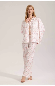 Detailed view of satin pajama set with pink heart print and silky fabric texture