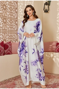 Detail of satin chiffon caftan dress featuring elegant purple floral prints and batwing sleeves