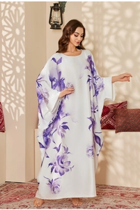 Detail of white satin kaftan featuring purple floral ink print and flowing batwing sleeves