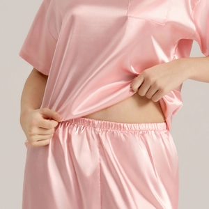 Pink silk satin pajama set for women featuring short sleeve top and matching shorts