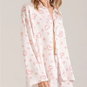 Three-piece satin pajama set for women featuring pink heart prints and long sleeves