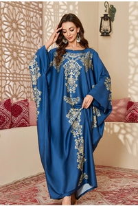 Detail of navy satin kaftan robe featuring intricate gold floral patterns and ethnic motifs