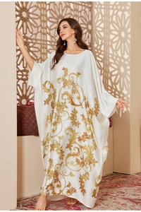 Detail of satin kaftan robe with baroque golden print and elegant batwing sleeves