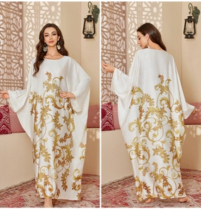 Detailed back and front view of a satin kaftan with golden baroque floral patterns
