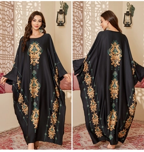 Front and back view of a black satin kaftan featuring gold and blue baroque patterns