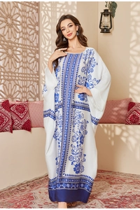 Detailed blue ethnic patterns on a white satin chiffon kaftan with wide sleeves